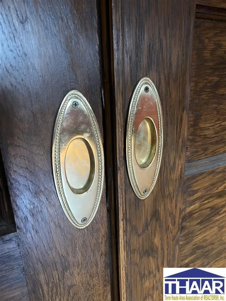 A close up of two doors with brass handles.