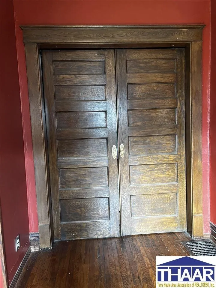 A pair of wooden doors in the corner of a room.