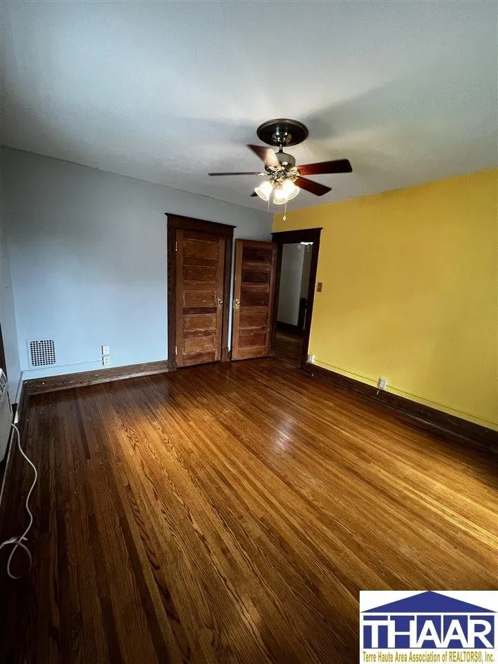 A room with wood floors and yellow walls.