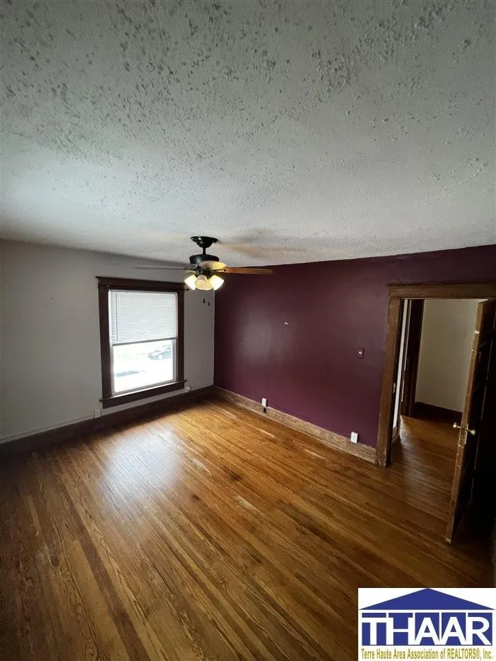 A room with wood floors and purple walls.