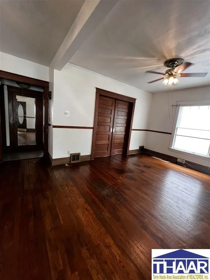 A room with wooden floors and white walls.