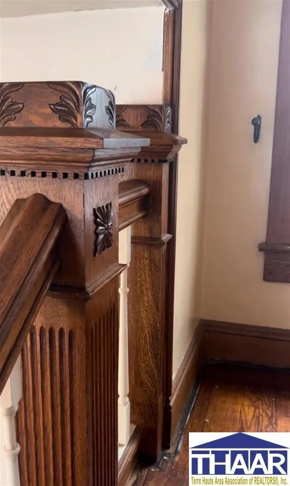 A wooden mantle with a clock on it.