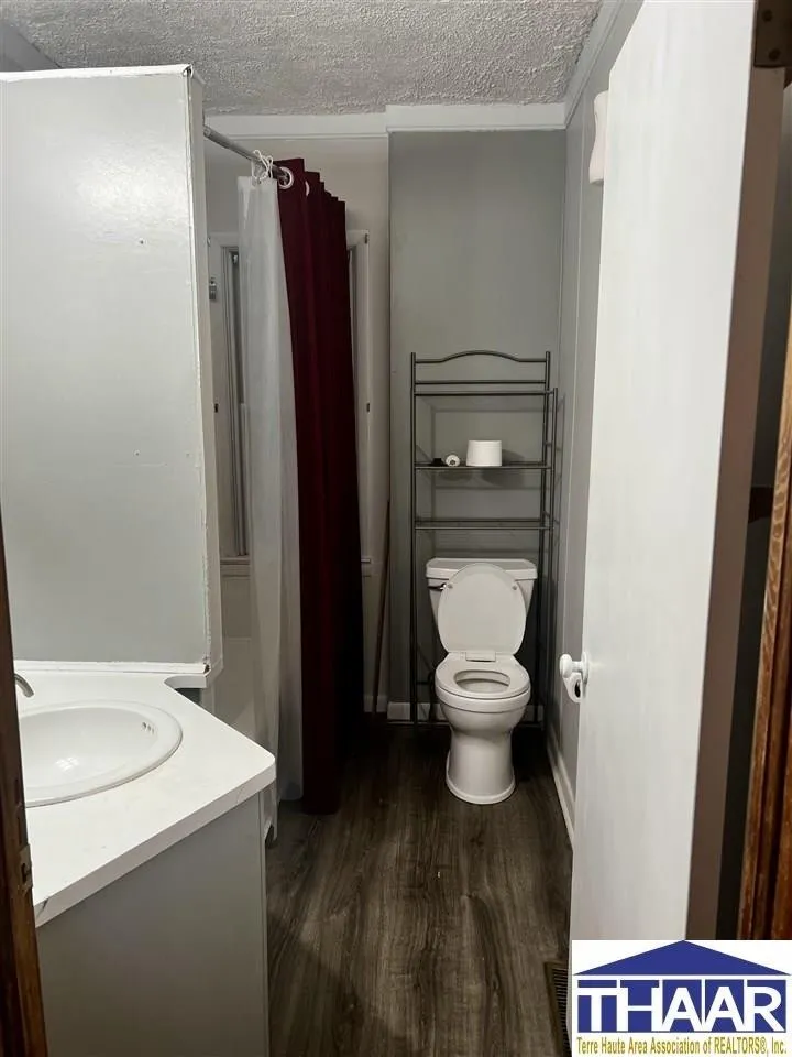 A bathroom with a toilet, tub and shower.